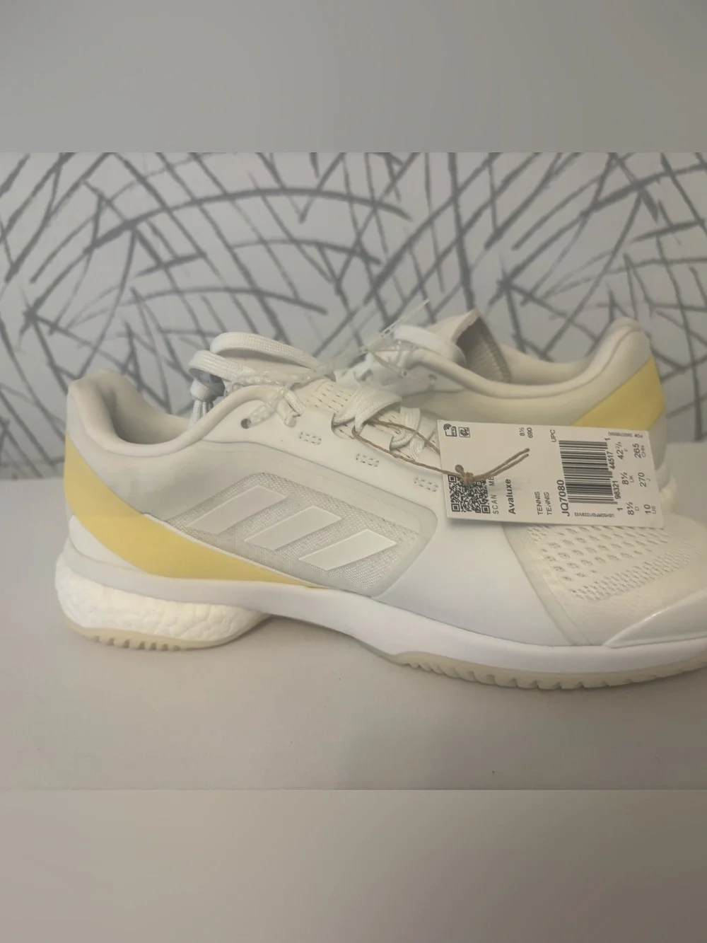 adidas Avaluxe tennis shoes in white with subtle pastel yellow accents. JQ7080